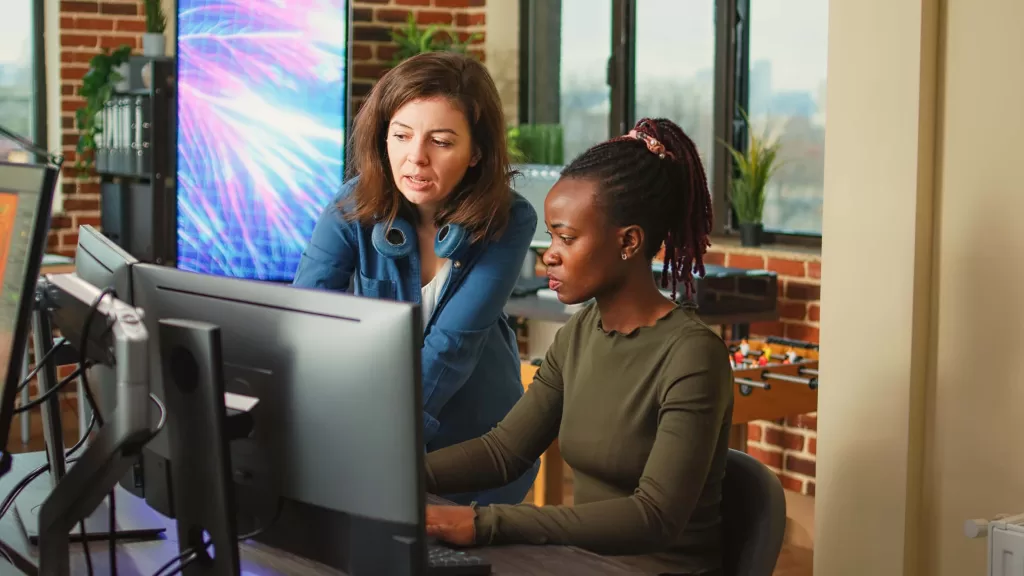 People doing teamwork to develop new interface in agency office, content creators analyzing infographics. Diverse team of colleagues working on 3d engineering with multiple monitors.